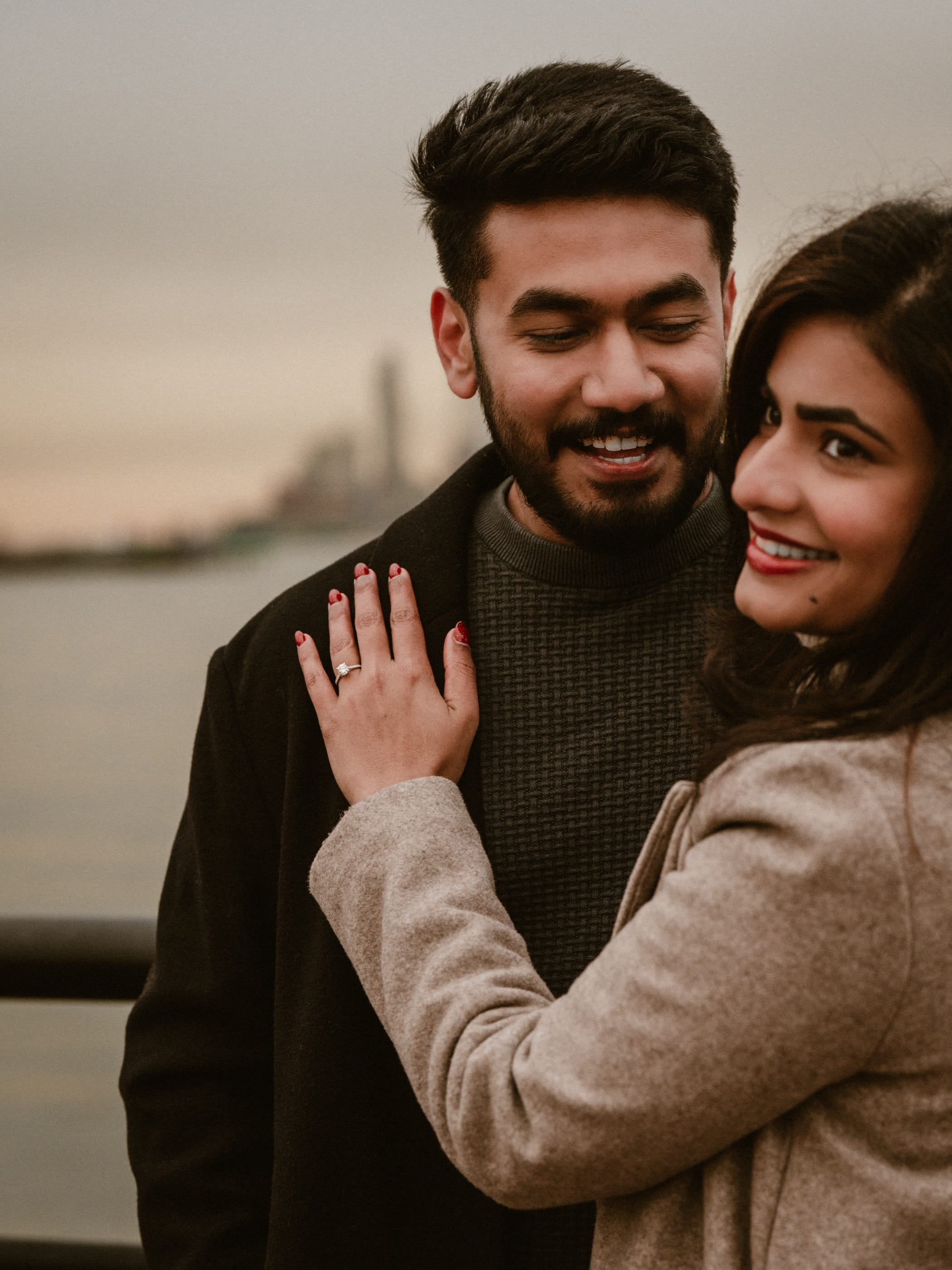 Athu's hand with the ring resting on Jes's chest