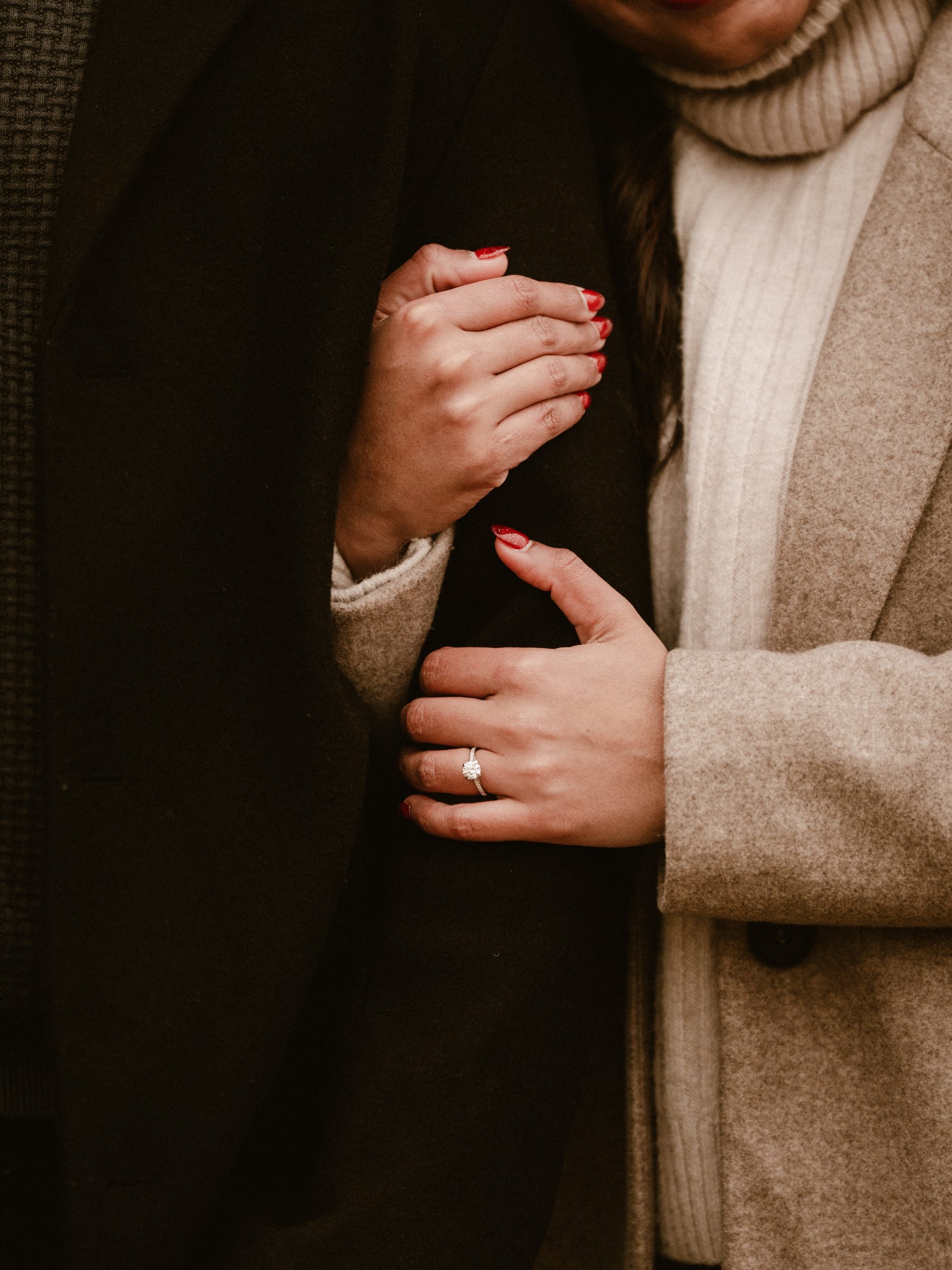 Arms linked close, ring in view