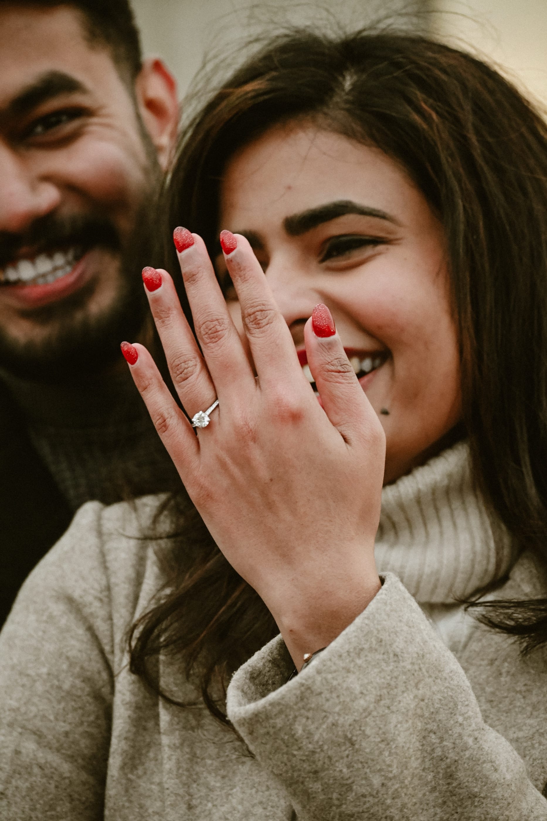 Athu showing off the ring while Jes laughs behind her