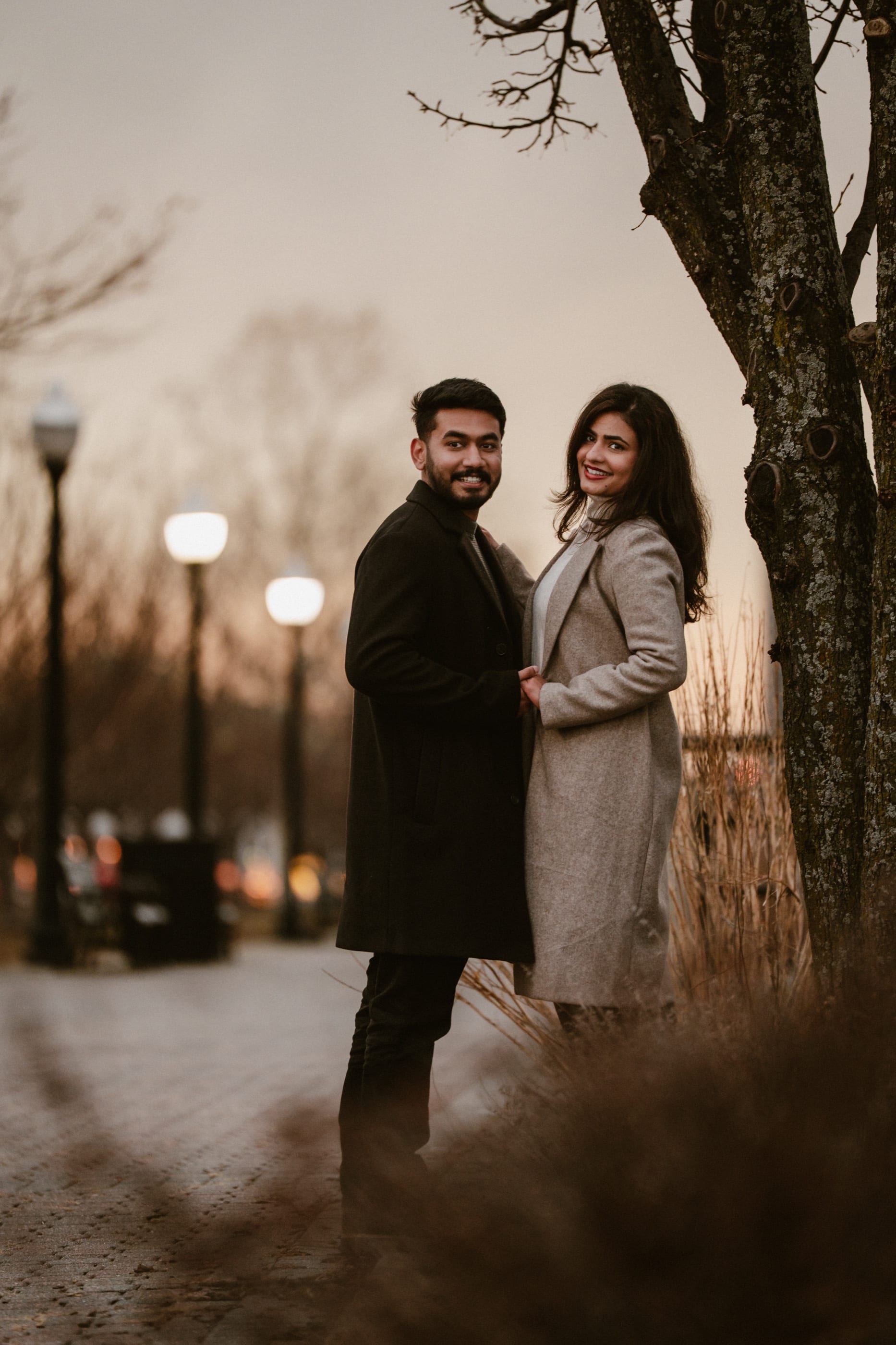 Together beneath a tree as the streetlamps glow